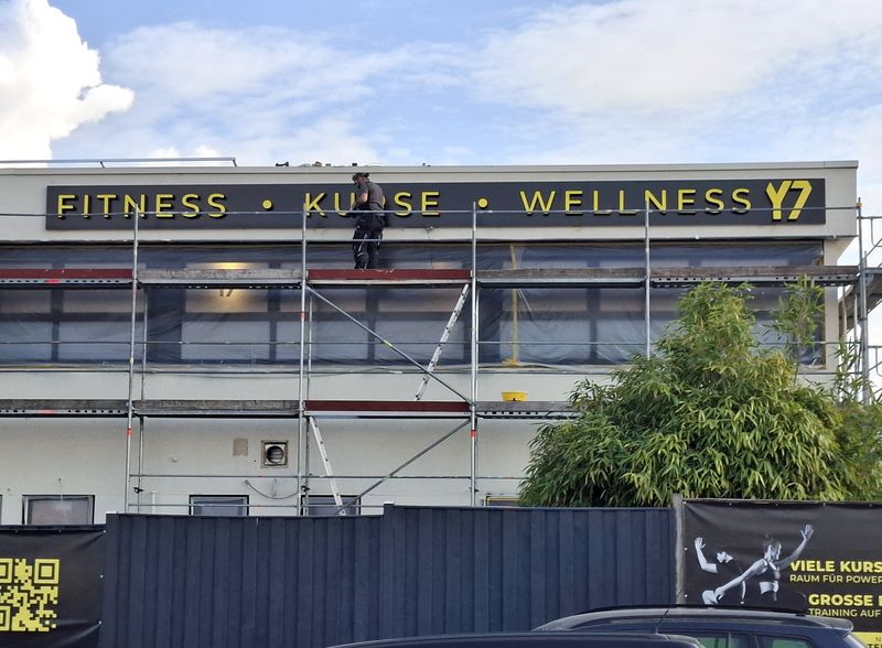 Moderne LED-Profilbuchstaben und Lichtwerbeanlage für das Fitnessstudio Y7 GYM. Hochwertige Außenwerbung mit beleuchteter Fassadenwerbung und LED-Leuchtschrift von Nematec.